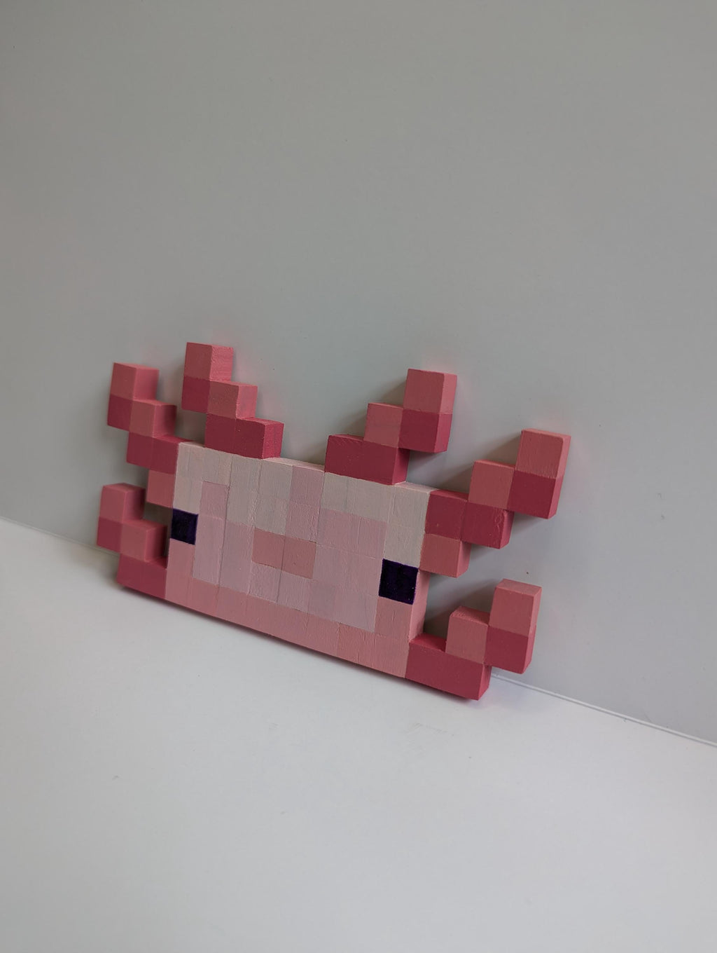 Wooden block Minecraft inspired hand painted Axolotl face.